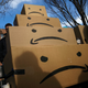 Boxes with the Amazon logo turned into a frown face are stacked up after a protest against Amazon in the Long Island City neighborhood of the Queens borough on November 14, 2018 in New York City.